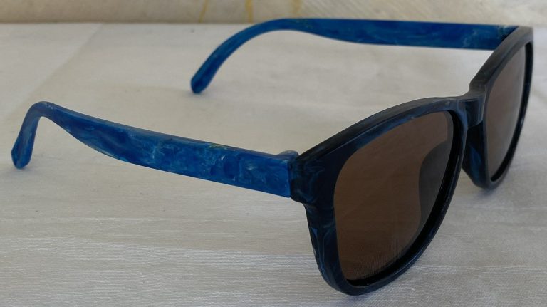Azure - Blue arm, black front, dark amber lens.